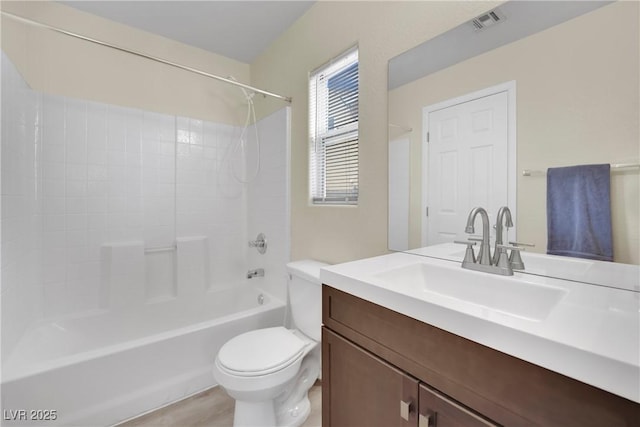 bathroom featuring toilet, shower / tub combination, visible vents, and vanity