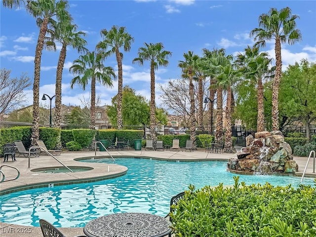 pool featuring a patio area, a hot tub, and fence