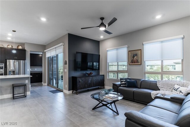 living room with light tile patterned floors and ceiling fan