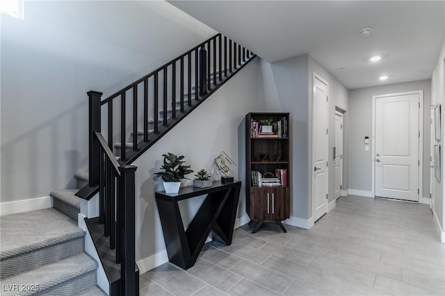 staircase with recessed lighting and baseboards