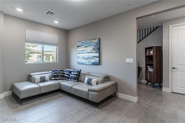 living room with light tile patterned floors, recessed lighting, visible vents, and baseboards