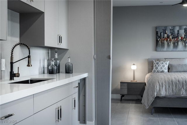 interior space with sink, white cabinets, and tile patterned floors