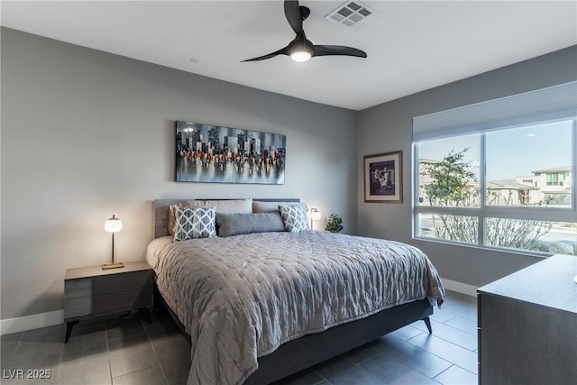 tiled bedroom featuring baseboards, visible vents, and ceiling fan