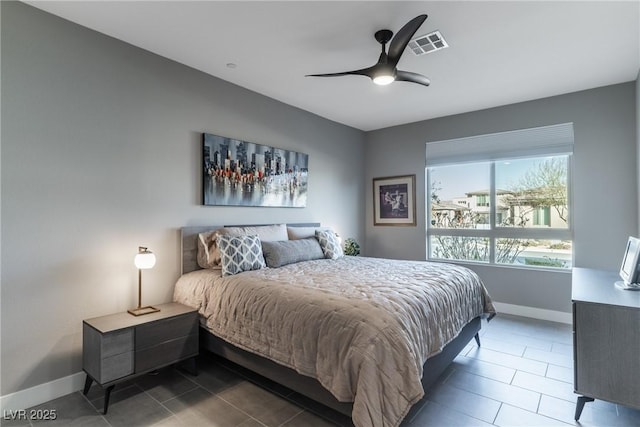 tiled bedroom featuring ceiling fan