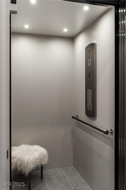 bathroom featuring tile patterned flooring and elevator