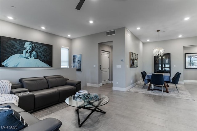 living area featuring baseboards, visible vents, and recessed lighting