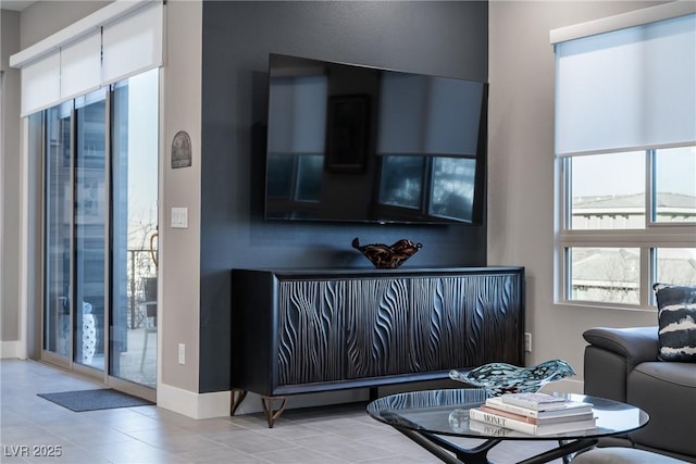 living room featuring tile patterned flooring and baseboards