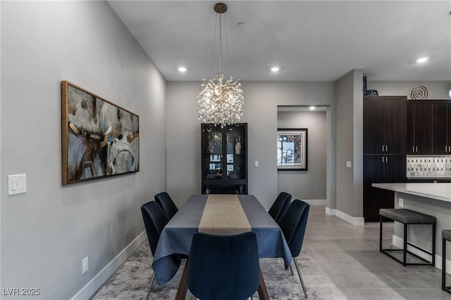 dining room with an inviting chandelier, baseboards, and recessed lighting