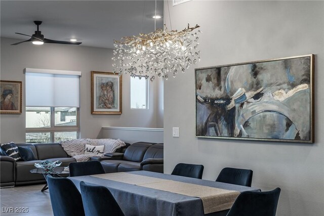 dining area featuring wood-type flooring and ceiling fan