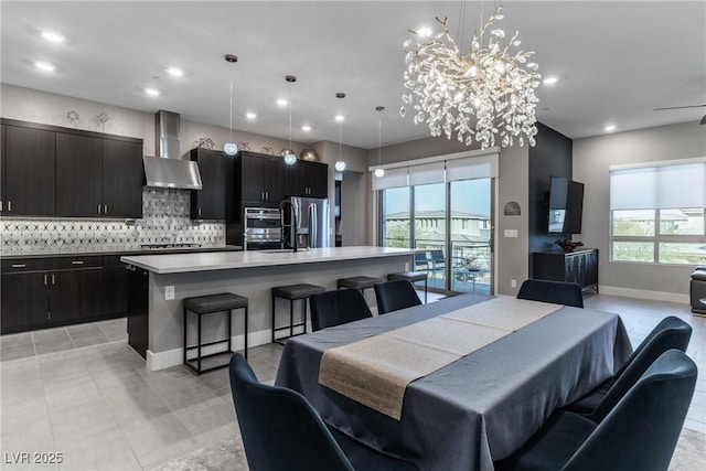 dining room with baseboards, light tile patterned flooring, and recessed lighting