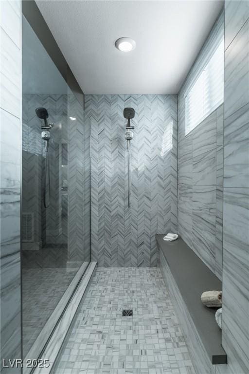 bathroom with tiled shower