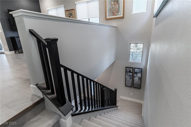 stairs featuring a high ceiling