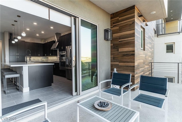 view of patio with an outdoor wet bar