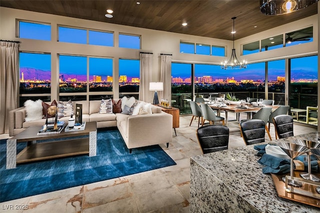 living area with recessed lighting, a towering ceiling, wood ceiling, and a notable chandelier