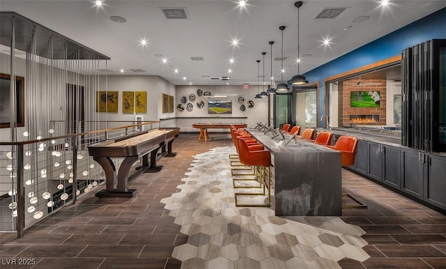 interior space with wood finish floors and visible vents