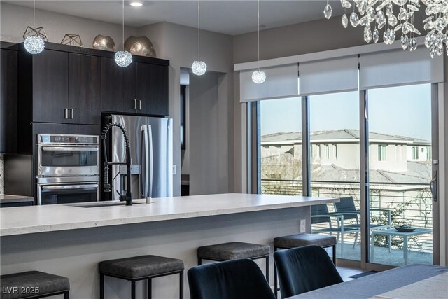 kitchen featuring hanging light fixtures, plenty of natural light, and stainless steel appliances