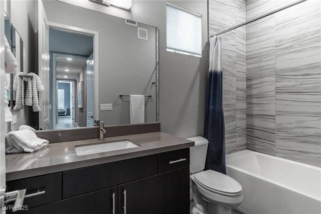 full bathroom featuring a textured wall, toilet, visible vents, vanity, and shower / tub combo with curtain