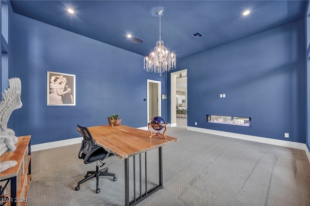 carpeted office featuring an inviting chandelier