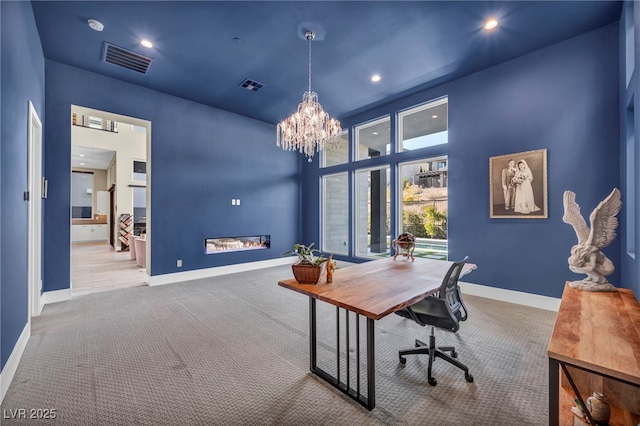 office featuring light colored carpet and a chandelier