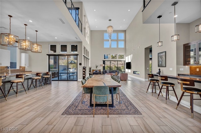 dining area with sink and light hardwood / wood-style flooring