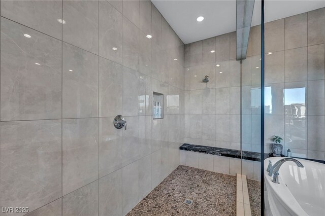 bathroom featuring separate shower and tub