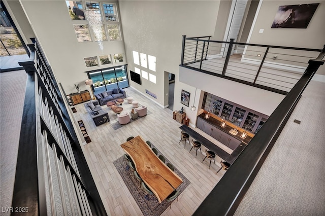 living room featuring a wealth of natural light and a high ceiling