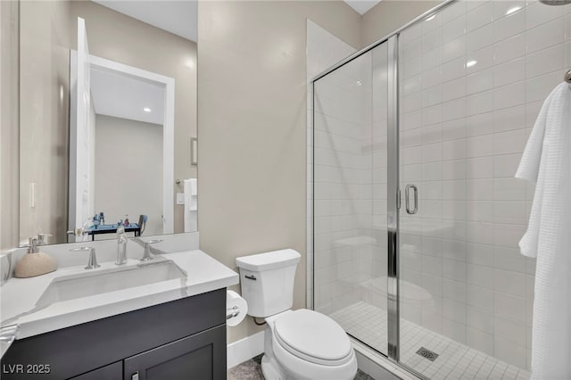 bathroom with vanity, an enclosed shower, and toilet