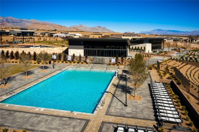 view of swimming pool featuring a patio and a mountain view