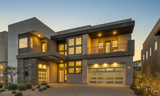 modern home featuring a balcony and a garage