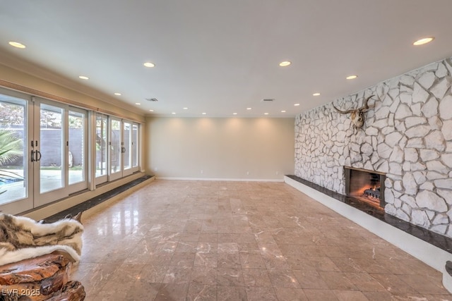 unfurnished living room featuring recessed lighting, visible vents, a fireplace, and baseboards