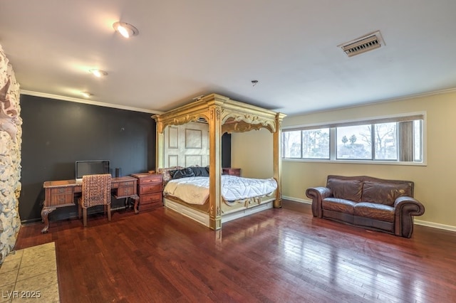 bedroom with baseboards, visible vents, dark wood-type flooring, and ornamental molding