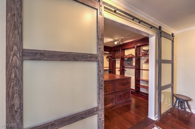 interior space with dark wood finished floors and a barn door