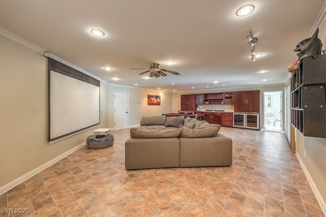 home theater featuring baseboards, ornamental molding, ceiling fan, and recessed lighting