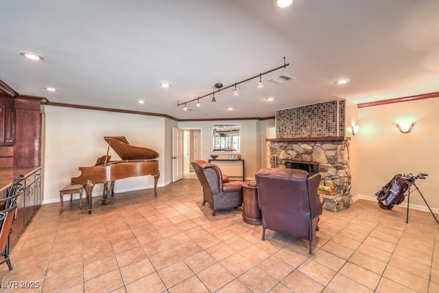 living room featuring baseboards, visible vents, crown molding, a fireplace, and light tile patterned flooring