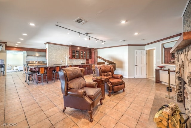 living room featuring ornamental molding, light tile patterned flooring, visible vents, and recessed lighting