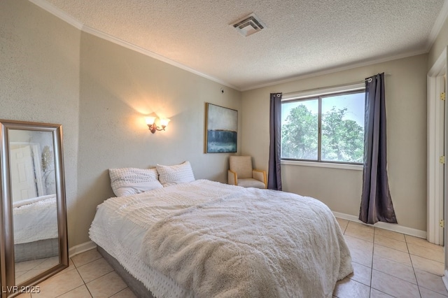 bedroom featuring crown molding, visible vents, light tile patterned flooring, a textured ceiling, and baseboards