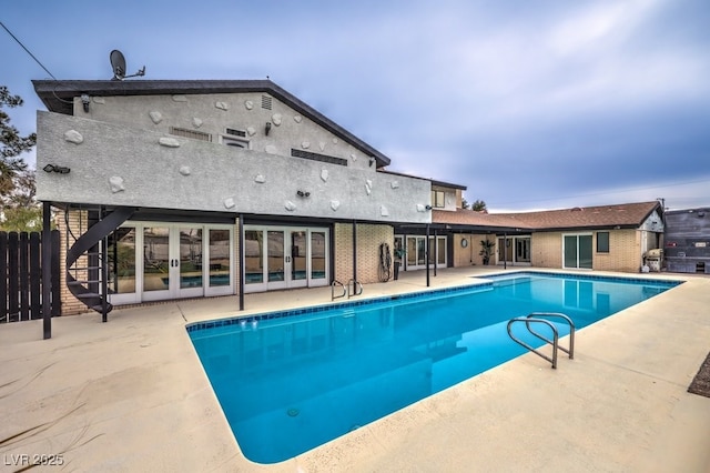 pool featuring fence and a patio