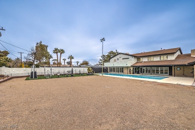 exterior space with fence and a fenced in pool