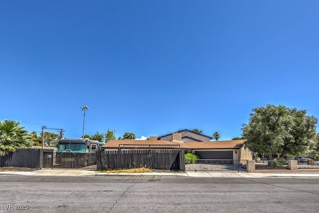 view of front facade with a fenced front yard and brick siding