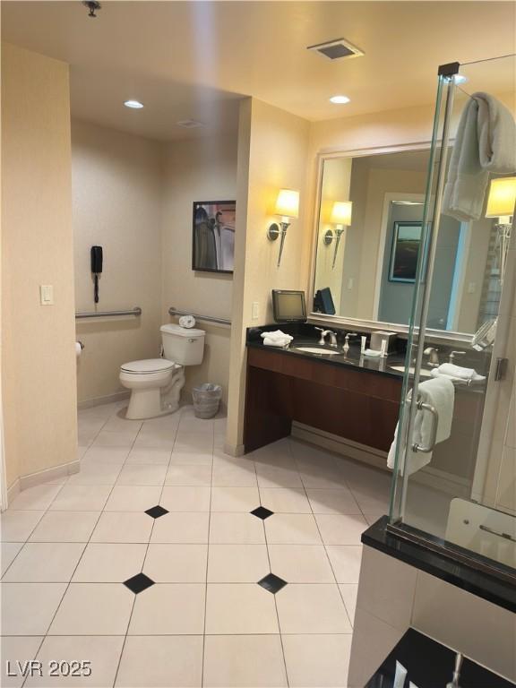 bathroom with tile patterned flooring, vanity, and toilet