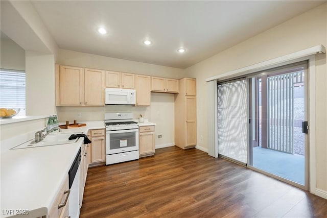 kitchen featuring white appliances, dark hardwood / wood-style floors, sink, and light brown cabinets