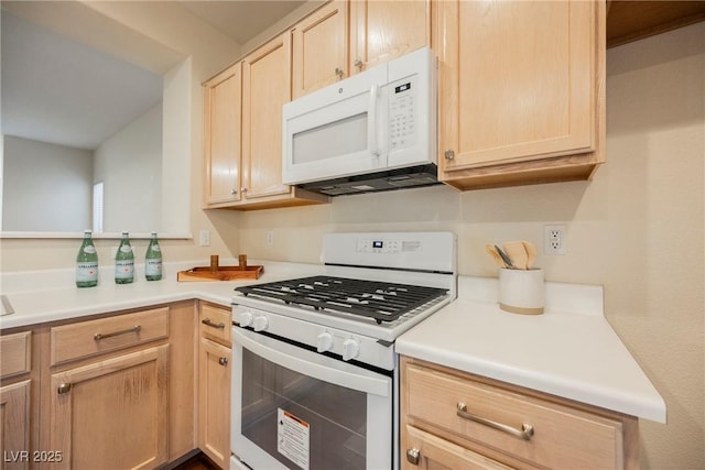 kitchen featuring white appliances and light brown cabinets