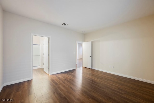 empty room featuring dark hardwood / wood-style flooring