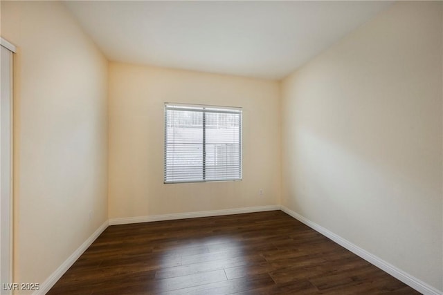 spare room with dark hardwood / wood-style flooring