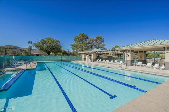 view of swimming pool featuring a mountain view and a patio area