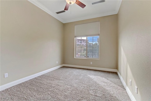 spare room with crown molding, ceiling fan, and carpet floors