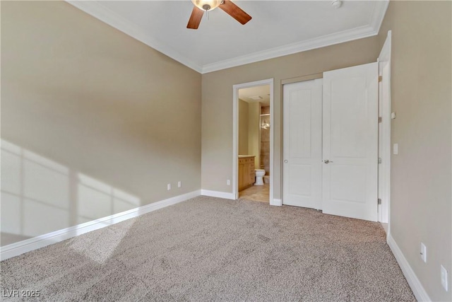 unfurnished bedroom featuring crown molding, light colored carpet, ceiling fan, and ensuite bathroom