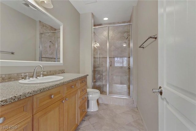 bathroom with tile patterned flooring, vanity, walk in shower, and toilet