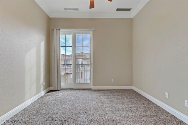 spare room featuring ornamental molding, carpet floors, and ceiling fan