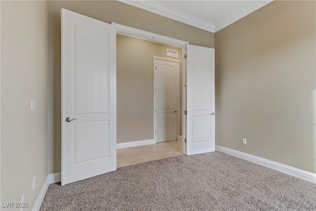 unfurnished bedroom featuring crown molding and light colored carpet